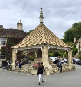 People at the Market Cross in Castle Combe