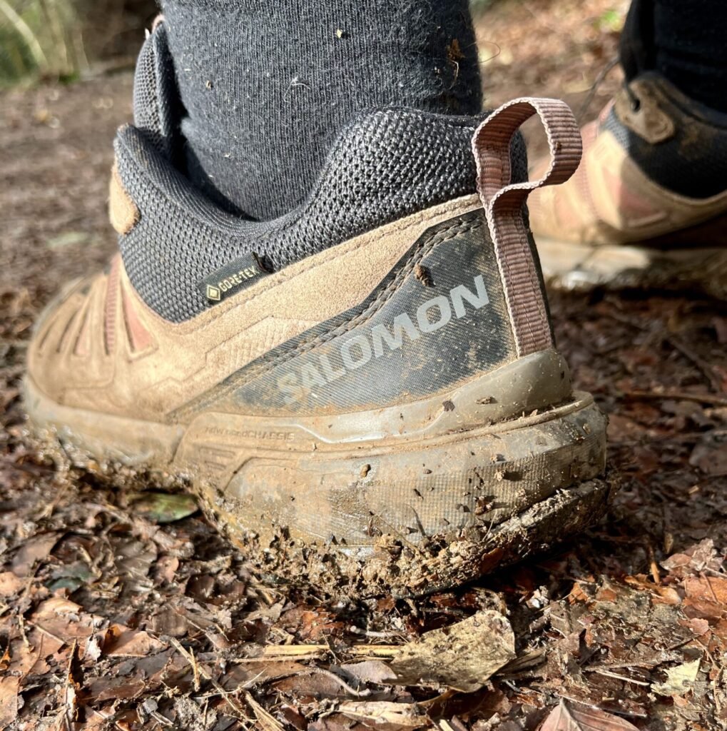 Salomon trail walking shoes on muddy path